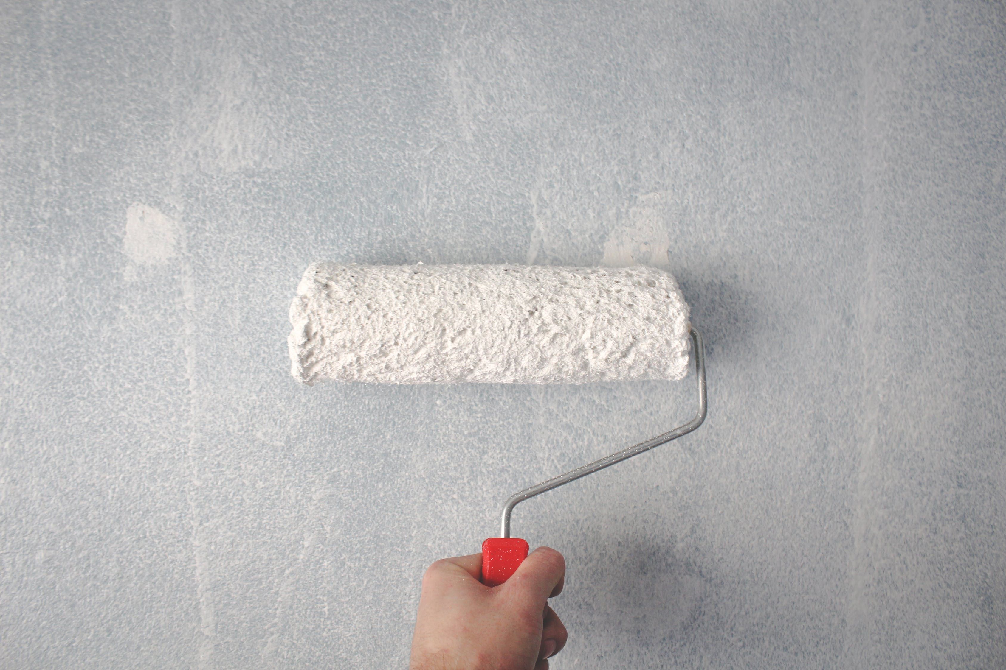 White paint being applied to a wall. 