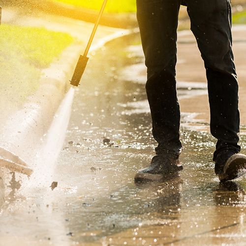 Painting contractors. Commercial Painters. Man Power washing outside.